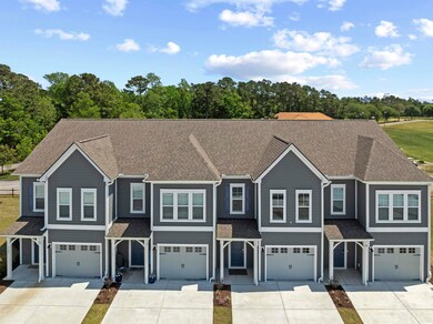 Townhome / multi-family property featuring roof with shingles, driveway, and a garage