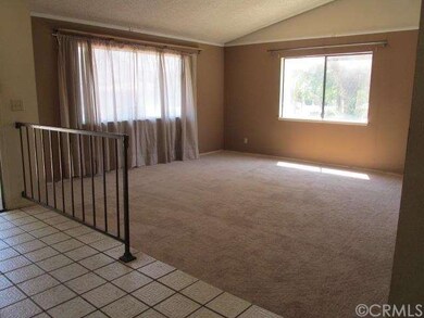 Raised tile entry leads to step-down formal living