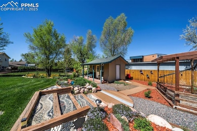 View of yard with an outdoor structure and a patio