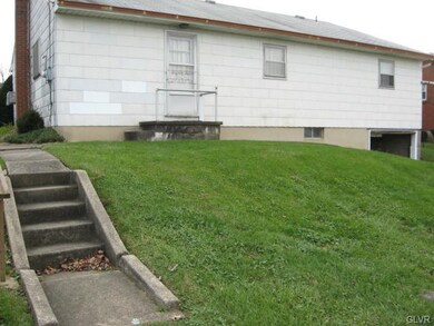 Sidewalk leading around the side of the house and 