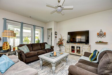 Living area featuring a ceiling fan and wood finished floors