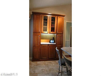 Kitchen. Built in Storage Hutch with LED lighting and granite counter.