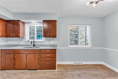 Kitchen with sink and light hardwood / wood-style flooring