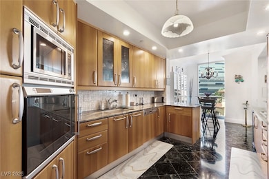 Kitchen with stainless steel microwave, oven, a si