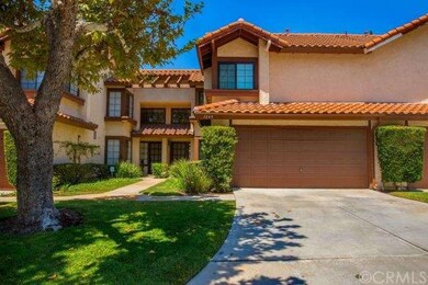 Well landscaped exterior with long driveway.