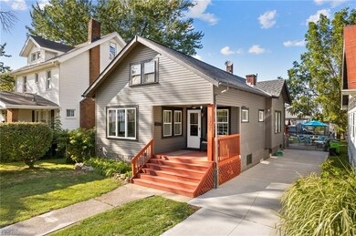 View of front of house featuring a front lawn and newer driveway.