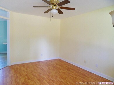 Living room also has wood laminate flooring and ce