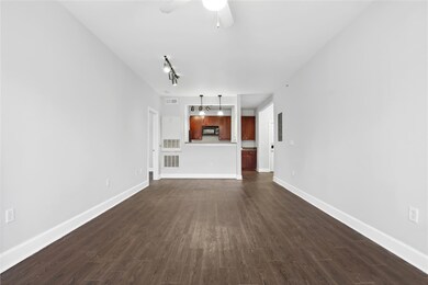 Unfurnished living room with dark wood-style floo