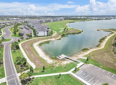 Birds eye view of property with a water view