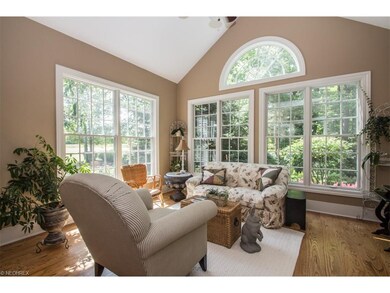 Sun room with hardwood flooring and cathedral ceil