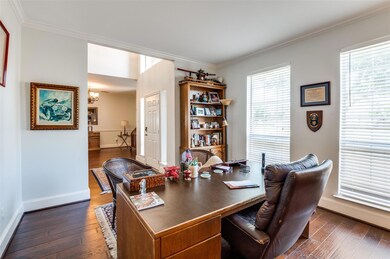 Home office with crown molding, a notable chandeli