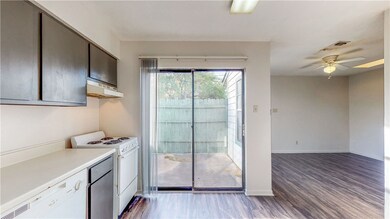 Kitchen featuring dark wood-type flooring, extract