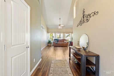 Hall with wood finished floors and a towering ceiling