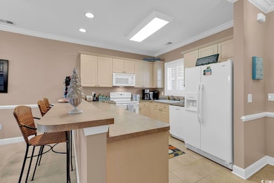 Kitchen with sink, a breakfast bar area, kitchen p