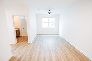 Spare room featuring ceiling fan, light wood fini