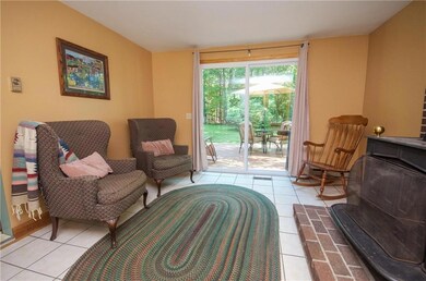 Sunny den with wood stove leads to...