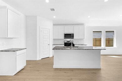 This Gourmet Kitchen will surround you with Tall Shaker Cabinets and Granite Countertops! **Image is of the Model Home and is a Representative of the Plan being Built**