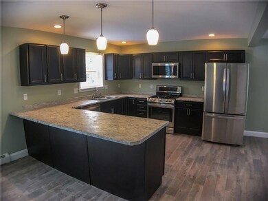Modern kitchen with full cabinetry &...