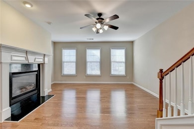 Unfurnished living room featuring wood finished fl