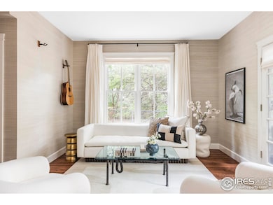 The adjacent family room offers flexibility as a music room, sitting area, or additional lounge, with its own French doors to the backyard.