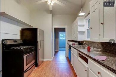 Kitchen with decorative light fixtures, light woo