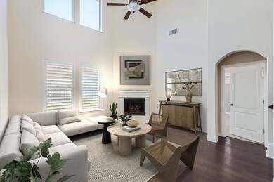 Living room featuring ceiling fan, a high ceiling,
