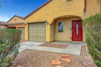 View of exterior entry with a garage, driveway, an