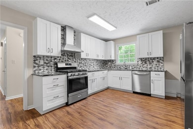 Large kitchen with new white cabinets and granite 