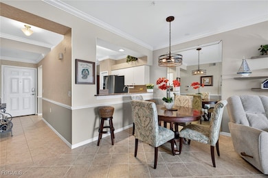 Dining room featuring ornamental molding and light tile patterned flooring