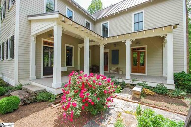 Expansive front porch overlooking herb garden and 