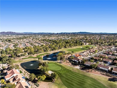 Aerial overview of property's location featuring nearby suburban area and a water and mountain view