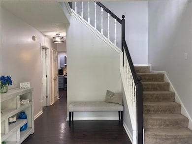 Staircase with baseboards and wood finished floors