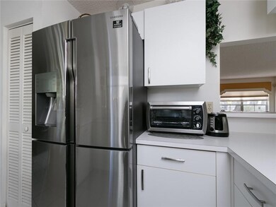 The kitchen has a beautiful brand new fridge raide