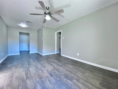 Unfurnished room featuring a textured ceiling, vis