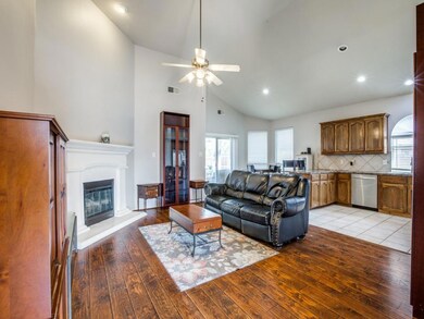 Living room featuring ceiling fan, high vaulted ce