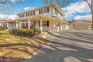 second angle displaying the attached and detached garages that can hold 4 cars.