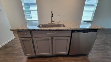Kitchen featuring stainless steel dishwasher, gra