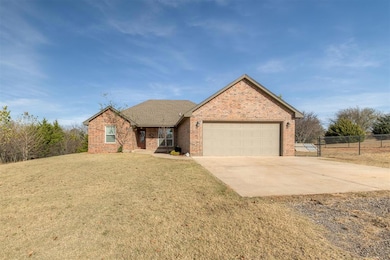 Single story home with concrete driveway, brick siding, an attached garage, a porch, and roof with shingles