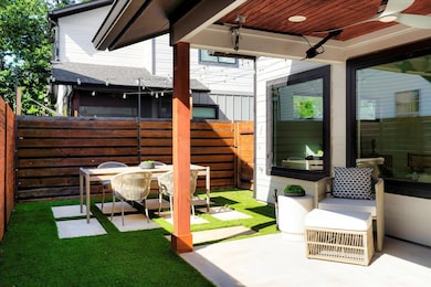 Fenced backyard with a patio and ceiling fan