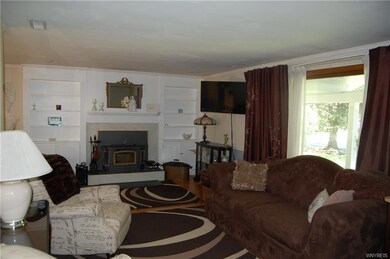 Living room has hardwood floors, wood burning fire