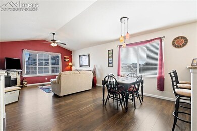 Dining room with dark hardwood / wood-style floors