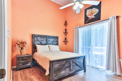 Bedroom with ceiling fan and wood-type flooring