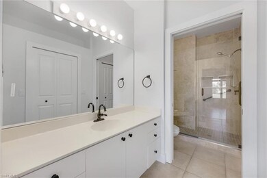 Bathroom featuring vanity, toilet, tile patterned 