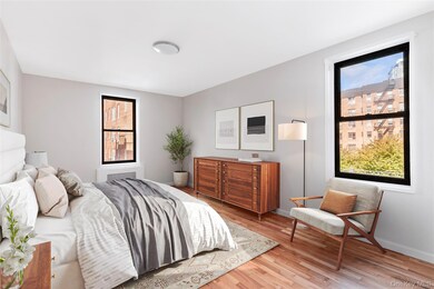 Bedroom featuring light wood finished floors and multiple windows