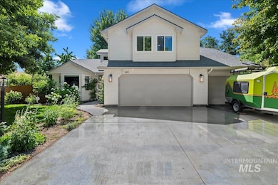 View of front facade with brick siding, concrete driveway, an attached garage, and roof with shingles