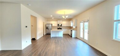 Kitchen featuring a kitchen island, stainless steel appliances, and a healthy amount of sunlight