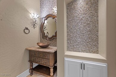 Modern Upgraded Bathroom downstairs with a textured wall and vanity up graded modern sink  downstairs off the kitchen