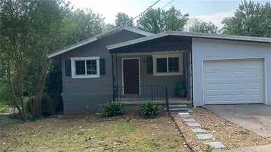 View of front of house with an attached garage and concrete driveway