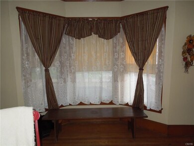 Living room with three large windows facing front 