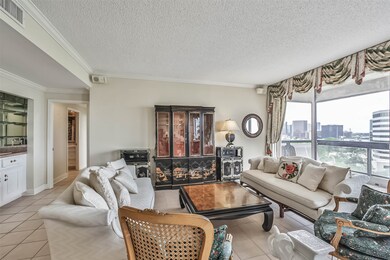 The living room opens to a balcony on one side and